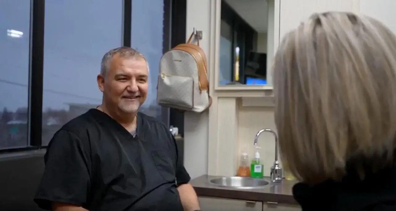 Dr. Stout smiling while consulting with a patient at Family First Dental in Rexburg Idaho