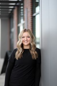 Portrait of Kiah, a dental assistant, smiling indoors, appears to be a professional staff headshot.