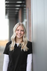 Portrait of Lexi, a dental assistant, smiling indoors, appears to be a professional staff headshot.