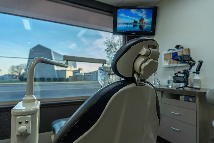 Family First Dental treatment room with patient chair, ceiling-mounted TV, and modern equipment.