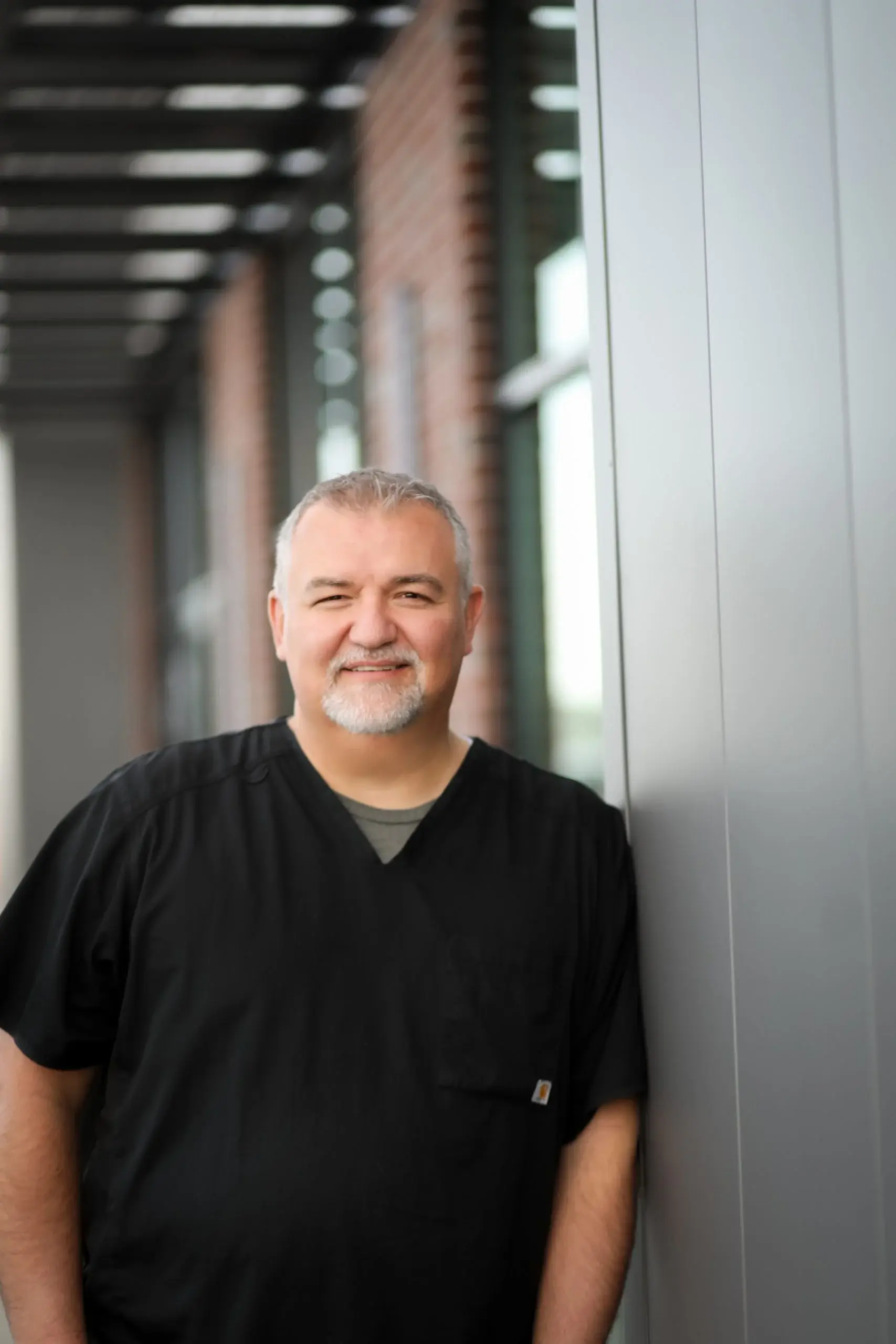 Smiling Family First Dentist team member wearing black scrubs in a professional portrait