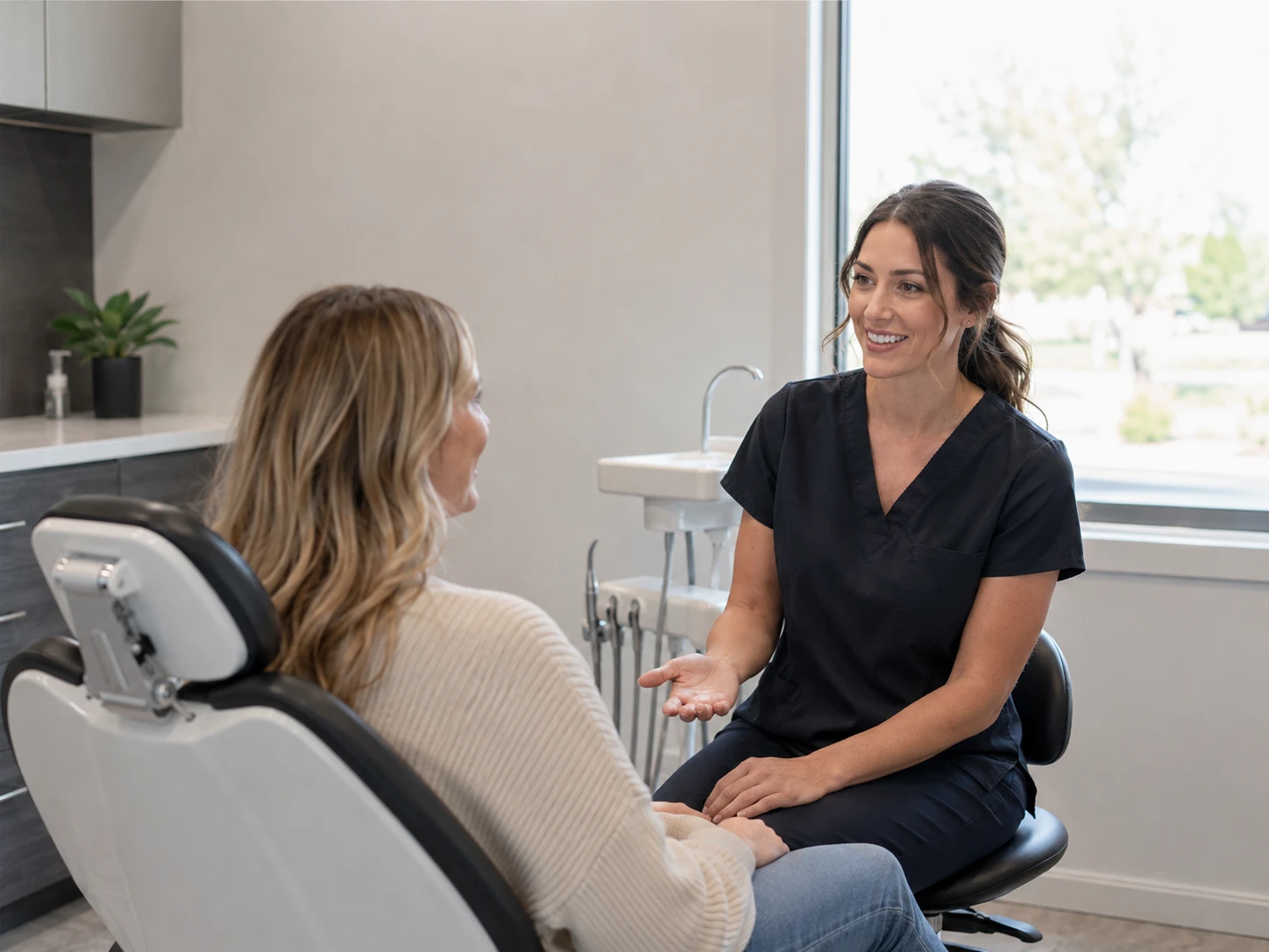 Dental team member discussing an in-house dental plan with a patient in Rexburg